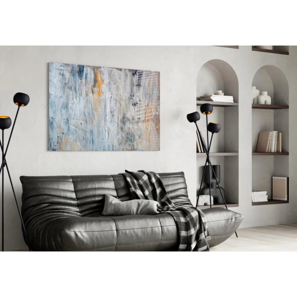 Sleek gray sofa under textured abstract wall art in blue gray tones