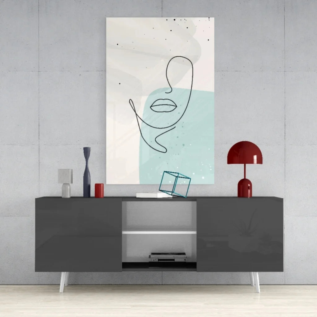 Modern abstract face glass wall art with minimalist black line drawing on pastel blue background
