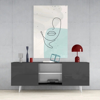 Modern abstract face glass wall art with minimalist black line drawing on pastel blue background