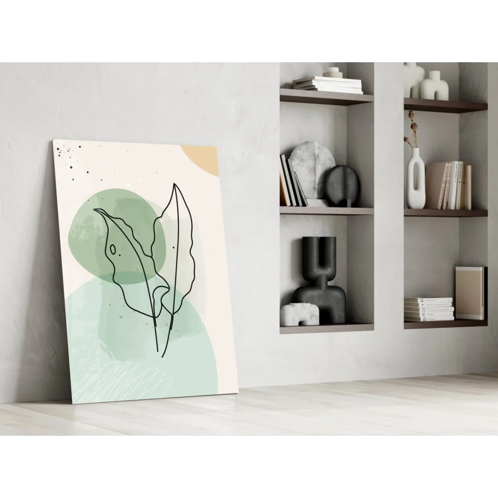 Minimalist glass wall art with abstract black leaf outlines on mint green background