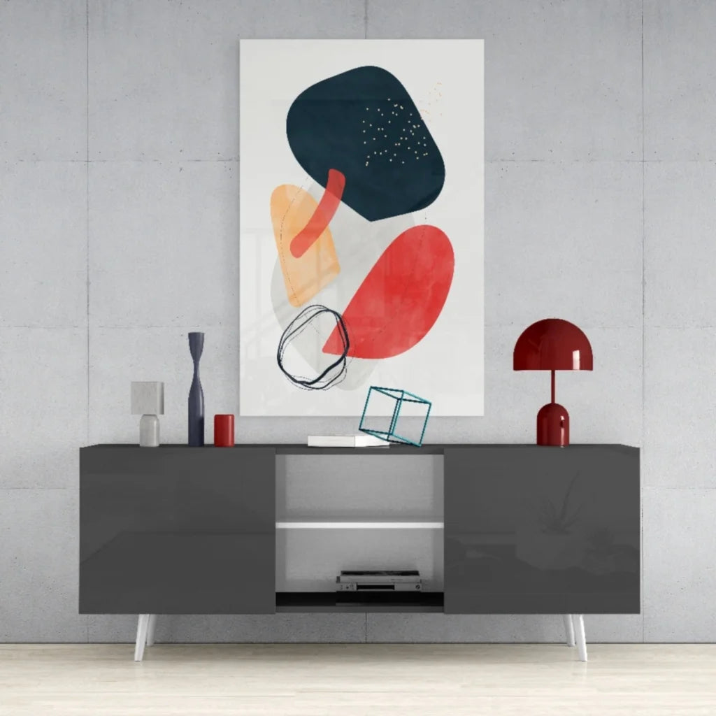 Bold abstract glass wall art with vibrant black, red, and orange geometric shapes on white