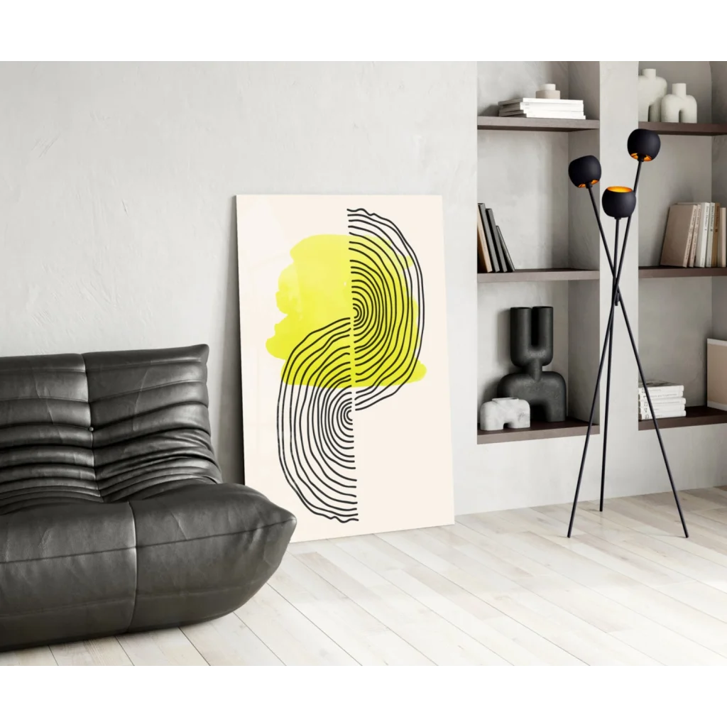 Modern abstract glass wall art with bold yellow black concentric lines on cream background