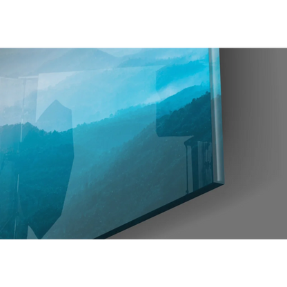 Sleek glass wall art of serene blue mountain sunset on TV screen