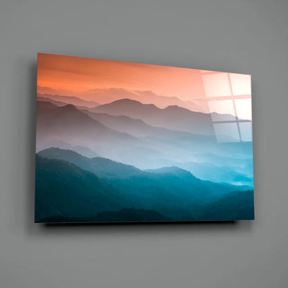 Sleek glass wall art of gradient mountain sunset in orange and blue hues