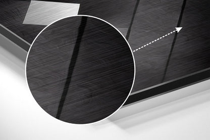 Three-dimensional brushed aluminum wall art featuring a large white-outlined circle with directional arrow on dark textured background, angled perspective view.