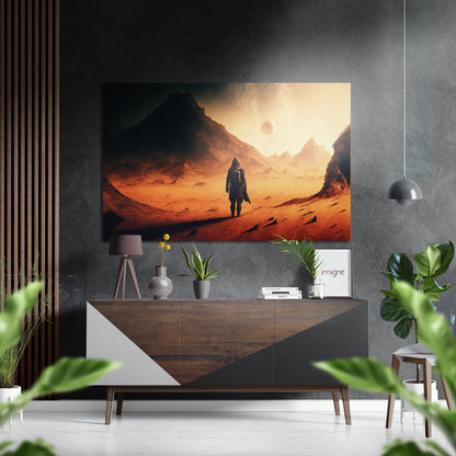 Brushed aluminum wall art depicting a solitary astronaut standing in an orange desert landscape with mountains and a planet in the sky, displayed above a wooden dresser in a modern interior.