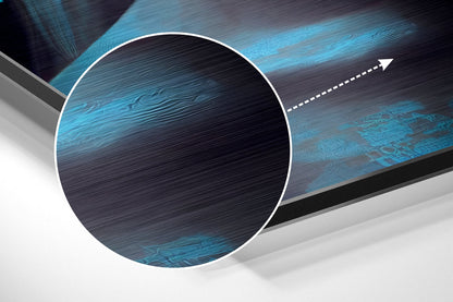 Abstract composition featuring a white-bordered circle with brushed blue and black textured aluminum surface and directional arrow graphic.