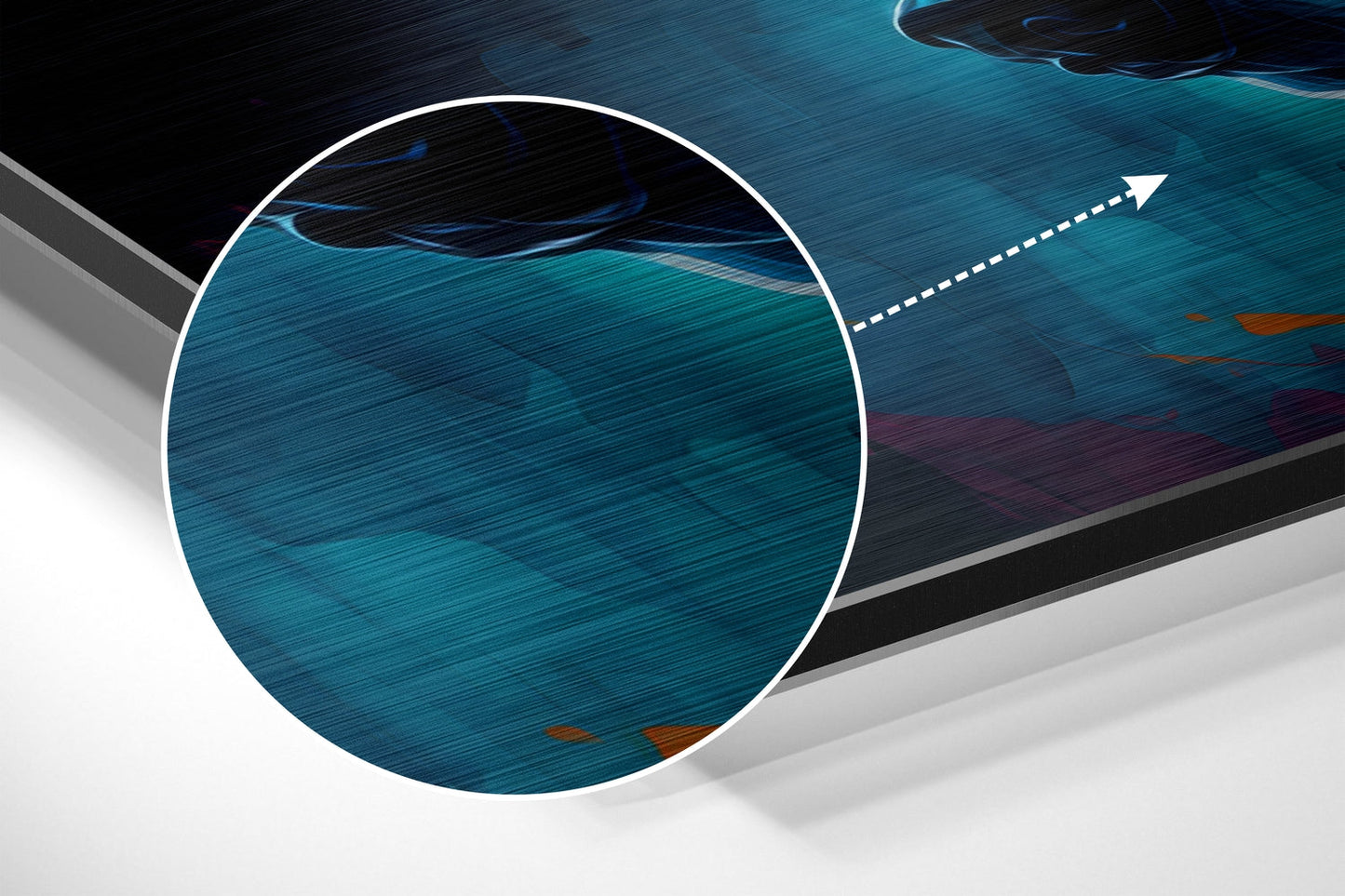 Close-up detail of brushed aluminum surface showing teal and dark blue layered textures with directional arrow indicator.