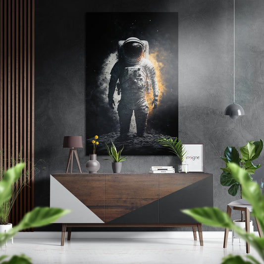 Golden Glow Moonwalk Astronaut Brushed Aluminum Dibond Wall Art displayed above a wooden dresser in a modern interior setting with plants and pendant lighting.