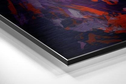 Angled close-up of layered aluminum dibond wall art showing orange and purple brushstrokes on dark surface with white base layers visible.