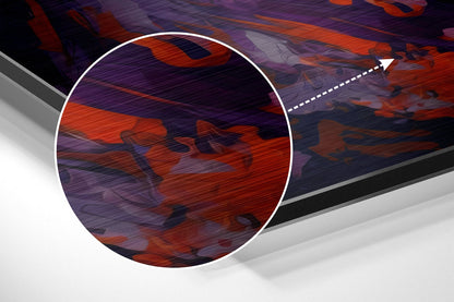 Magnified detail of brushed aluminum wall art showing red and purple abstract brushstrokes with textured surface.