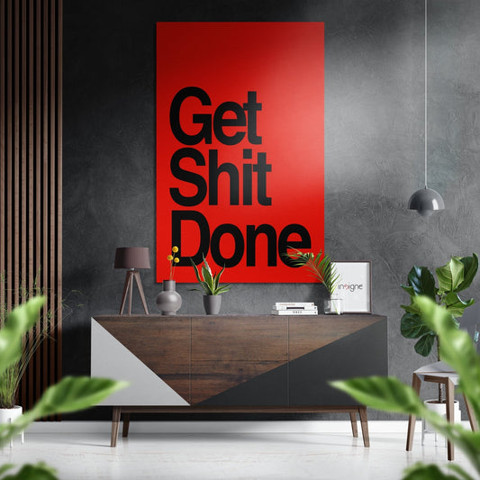 Red "Get Shit Done" motivational wall art displayed above a wooden mid-century console table in a modern interior setting.