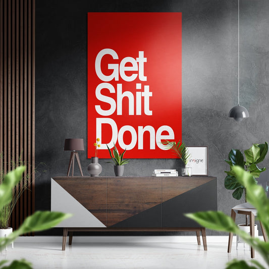 Red motivational wall art with white sans-serif text mounted above a wooden dresser in a modern interior setting.