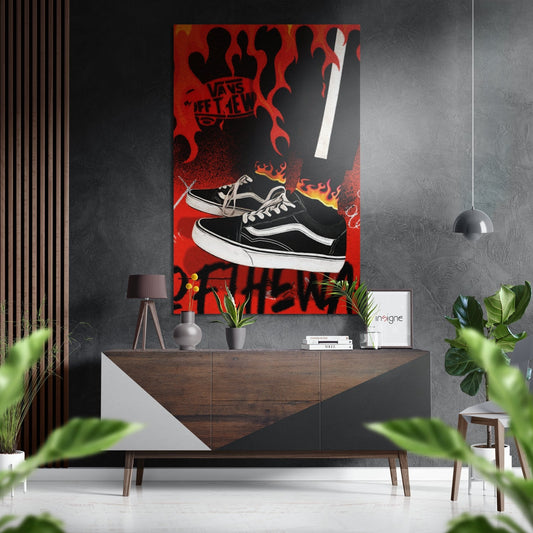 Red and black Vans sneaker wall art with flame graphics displayed above a wooden console table in a modern interior setting.