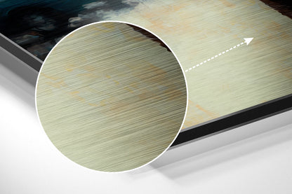 Close-up detail of brushed aluminum surface showing horizontal grain texture in pale green and tan tones with directional arrow.