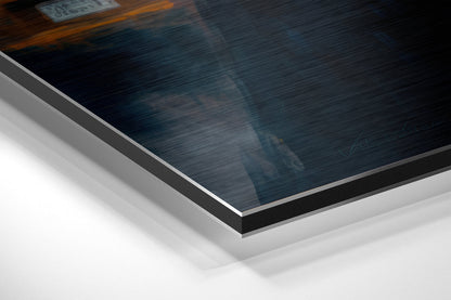Close-up angled view of brushed aluminum Dibond panel showing dark blue textured surface with silver metal edge trim and white backing layers.