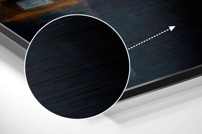 Angled perspective view of brushed aluminum Dibond wall art featuring a large black circle with white border and directional arrow on dark textured background.