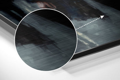 Close-up angled view of brushed aluminum surface showing horizontal texture and directional arrow graphic in white on dark blue-gray toned panel.
