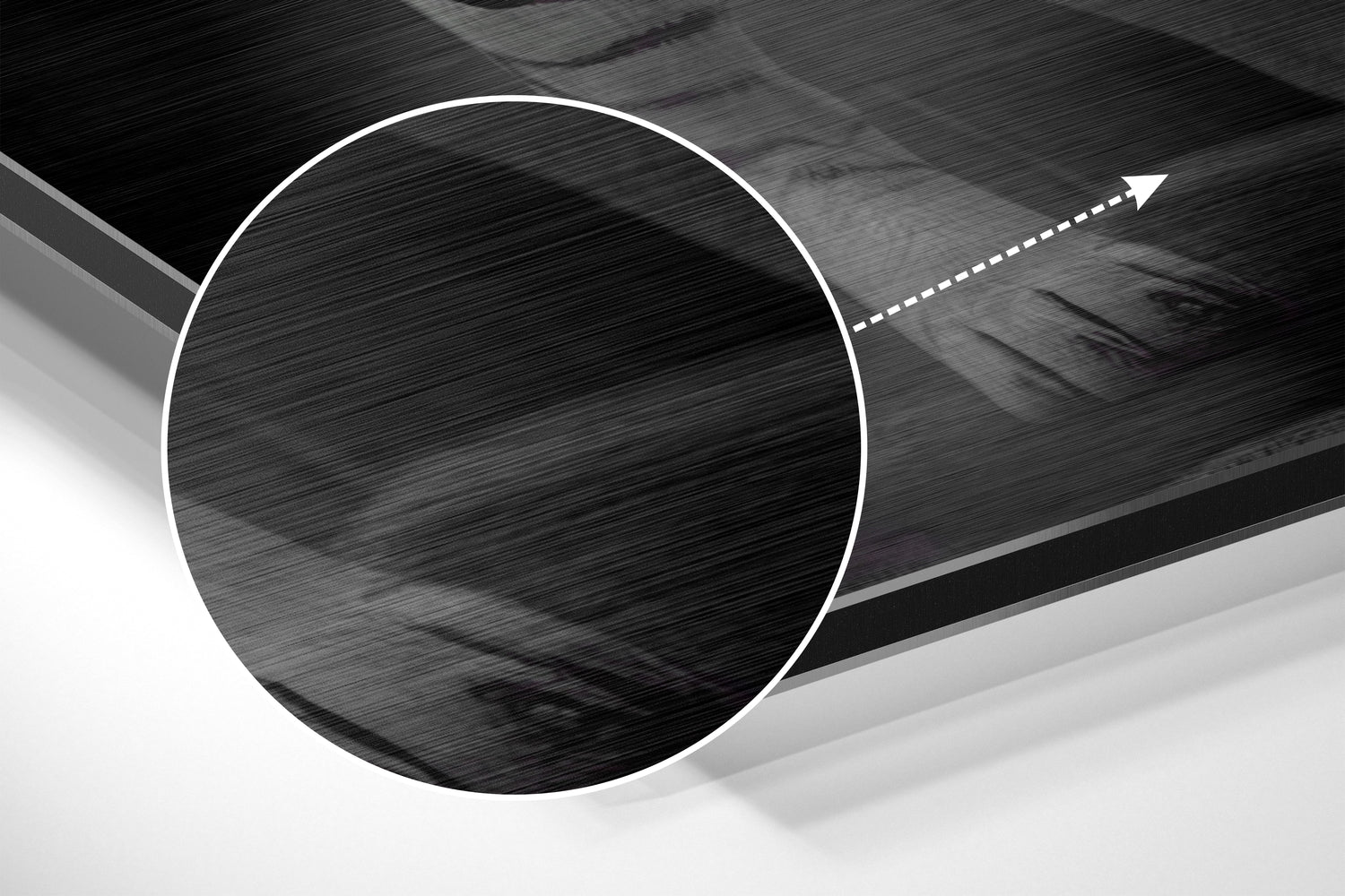 Close-up detail of brushed aluminum surface with circular cutout and directional arrow indicator on dark abstract wall art.