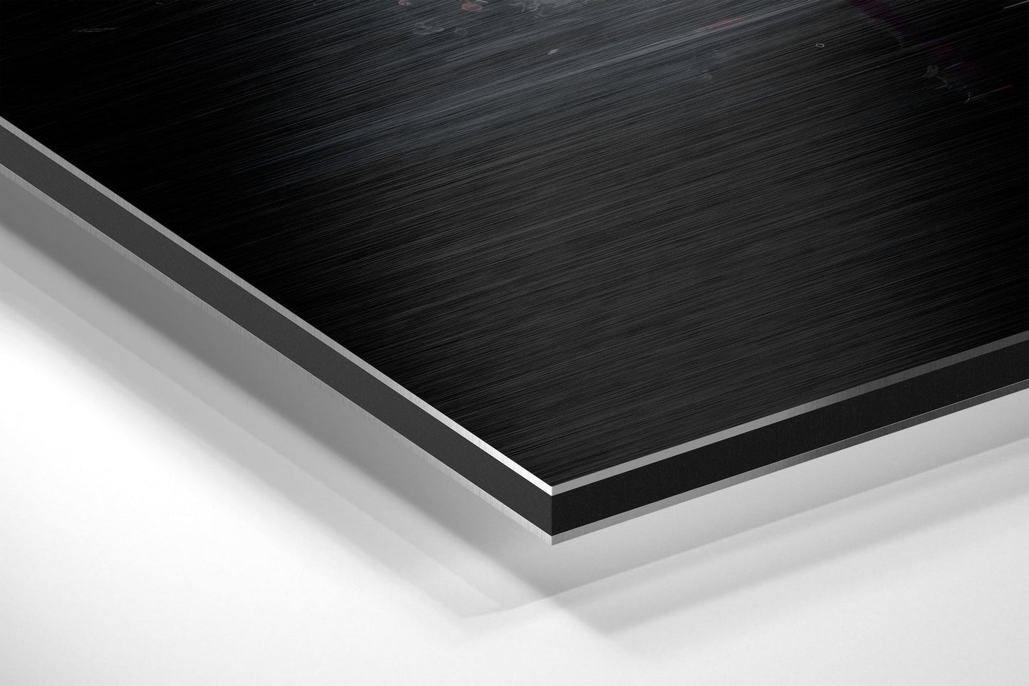 Angled close-up of layered brushed aluminum and white composite materials showing edge detail and surface texture.