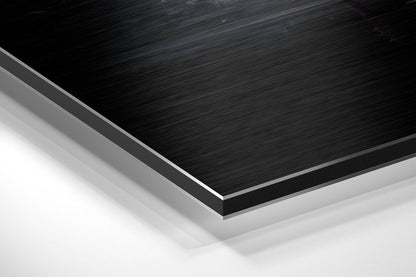 Angled close-up of layered brushed aluminum and white composite materials showing edge detail and surface texture.