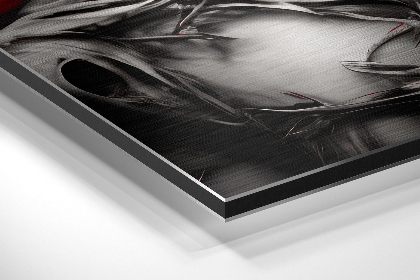 Close-up angled view of brushed aluminum Dibond art panel showing metallic surface texture with black border edge and white background.