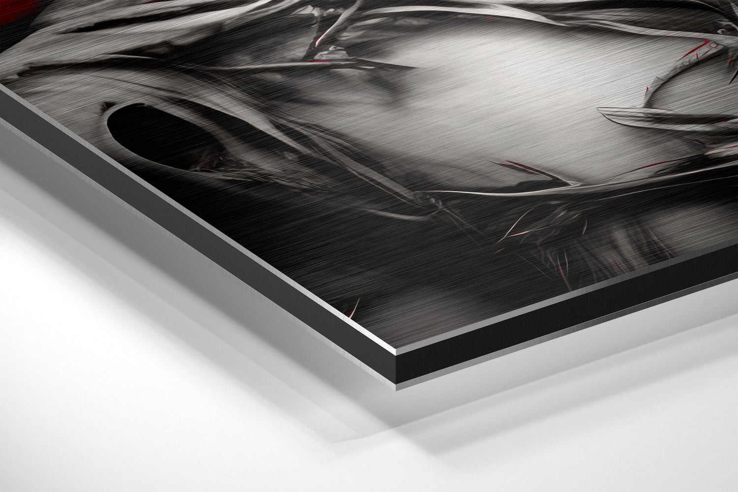 Close-up angled view of brushed aluminum Dibond art panel showing metallic surface texture with black border edge and white background.