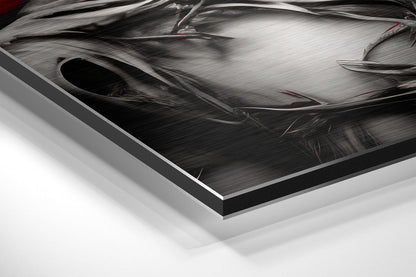Close-up angled view of brushed aluminum Dibond art panel showing metallic surface texture with black border edge and white background.