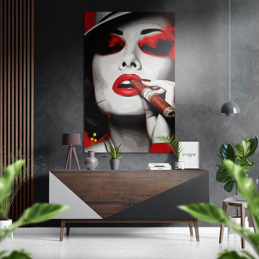 Modern interior display featuring red and white portrait artwork of woman with sunglasses and cigar above wooden mid-century console table with accessories.