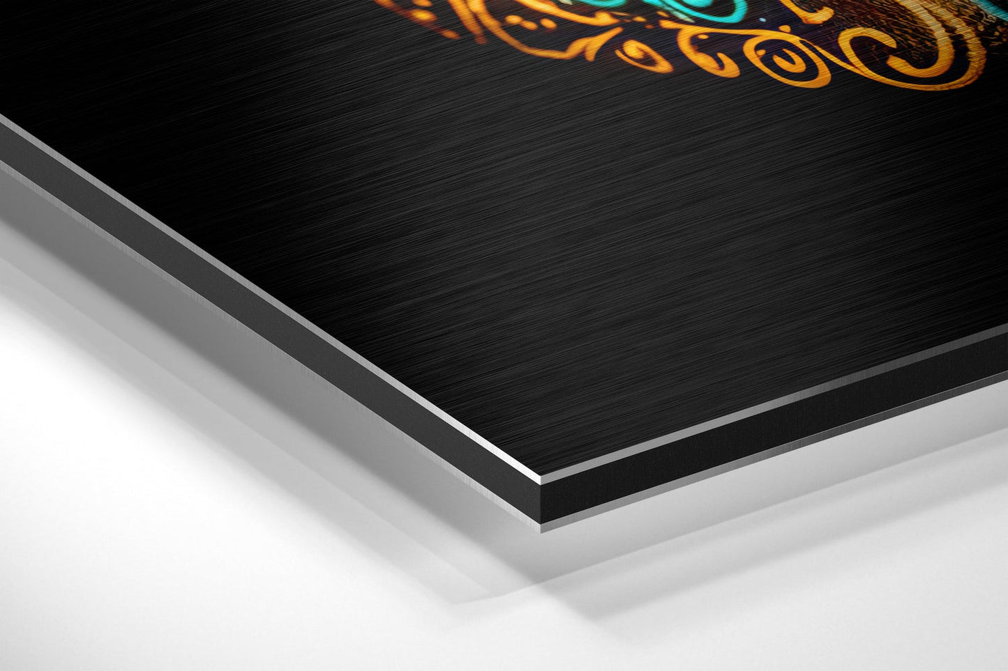 Close-up angled view of layered brushed aluminum and white backing of skull wall art with orange and teal decorative design.