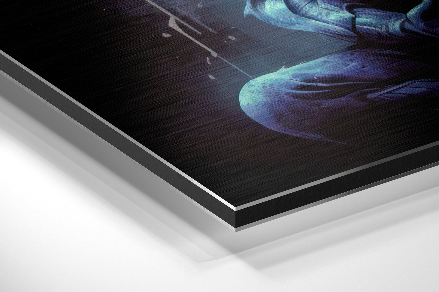 Close-up angled view of layered Dibond wall art showing brushed aluminum edge and white backing with blue-toned ethereal figure print.