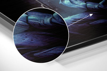 Close-up detail of brushed aluminum surface showing blue and teal streaked texture with directional arrow indicator.