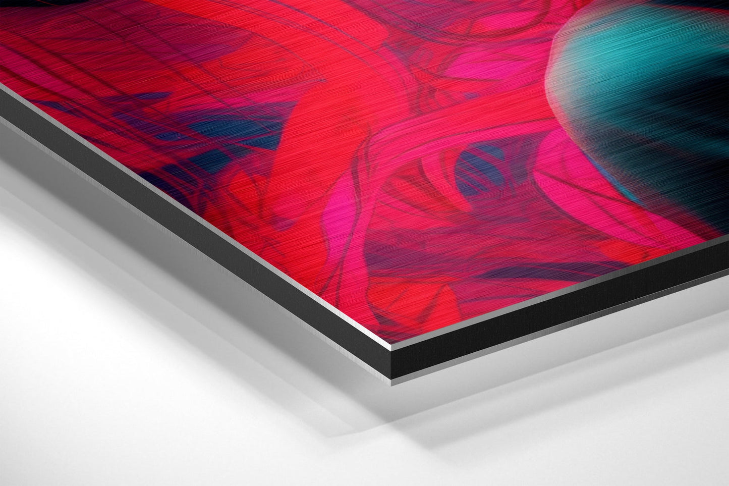 Angled close-up view of stacked Dibond panels showing vibrant red and magenta abstract brushstrokes with cyan accents on top layer.