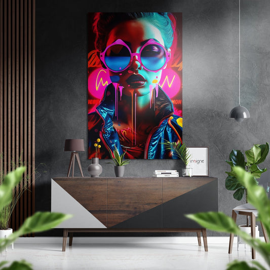 Neon pop art portrait of a woman wearing oversized pink sunglasses and colorful jacket displayed above a wooden console table in a modern interior setting.