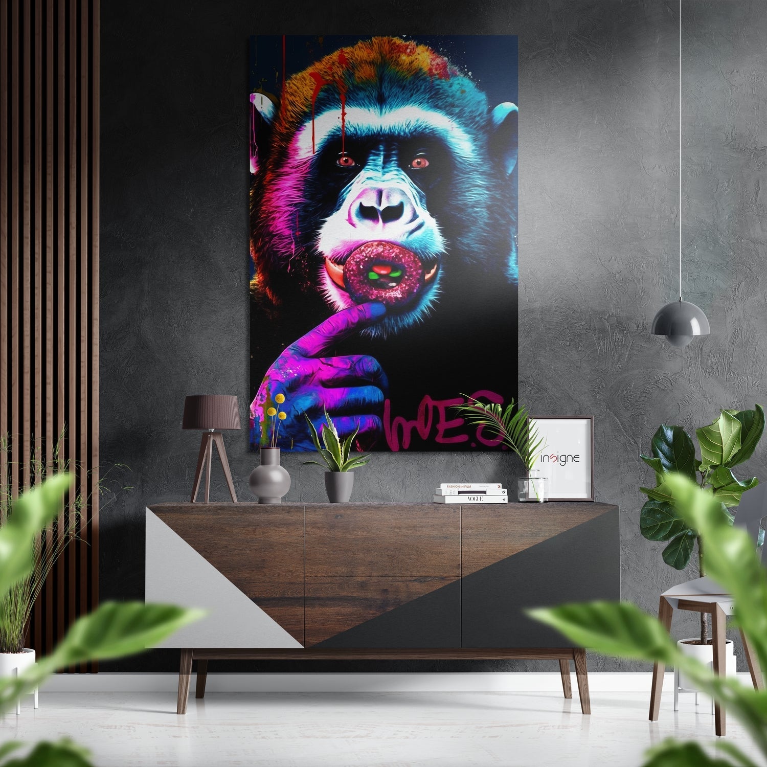 Colorful pop art monkey with pink donut displayed on gray wall above wooden dresser in modern interior setting.