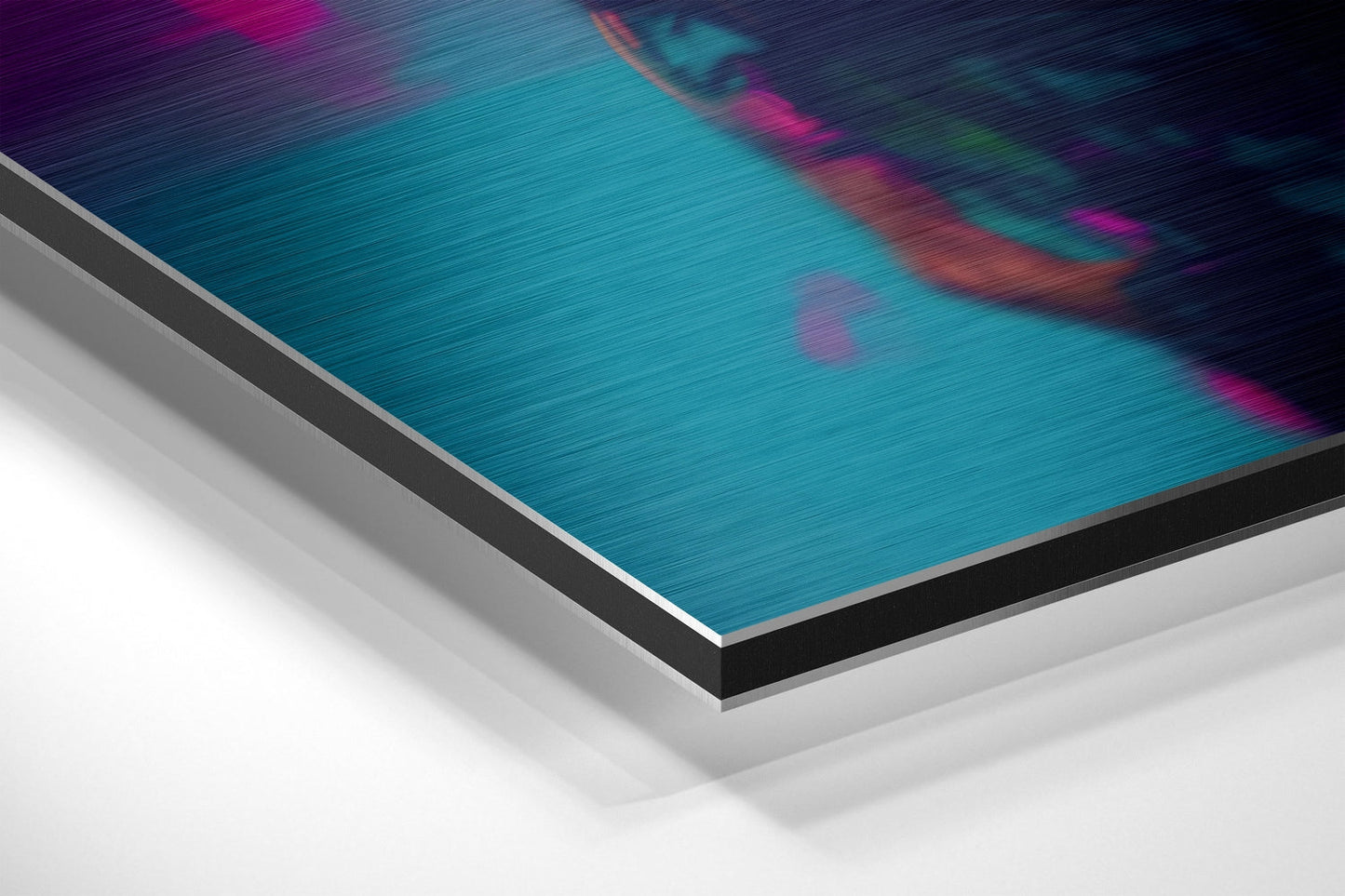 Angled view of brushed aluminum Dibond wall art with turquoise and magenta abstract design on layered edge.