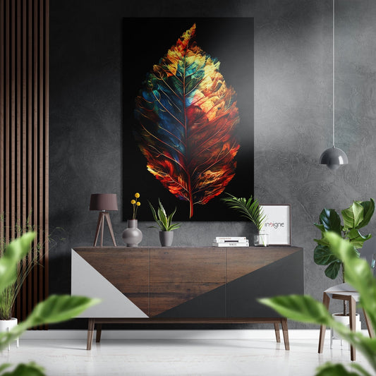 Colorful feather art with red, orange, yellow, and blue tones displayed on dark wall above wooden dresser in modern interior setting.