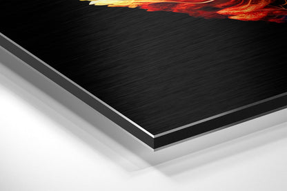 Angled perspective view of layered Dibond wall art showing brushed black aluminum surface with white backing and gold-red flame detail at top edge.