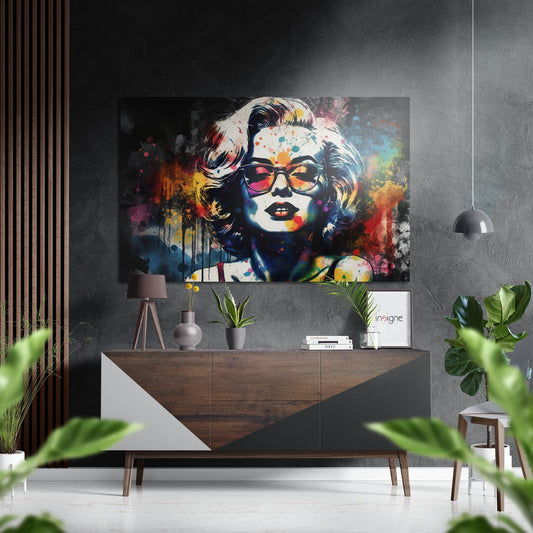 Colorful pop art portrait of blonde woman wearing sunglasses displayed above wooden dresser in modern living room setting.