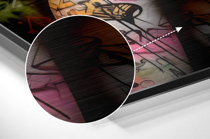 Close-up detail of brushed aluminum Dibond wall art showing textured metallic surface with pink and black abstract design elements and white circular overlay.