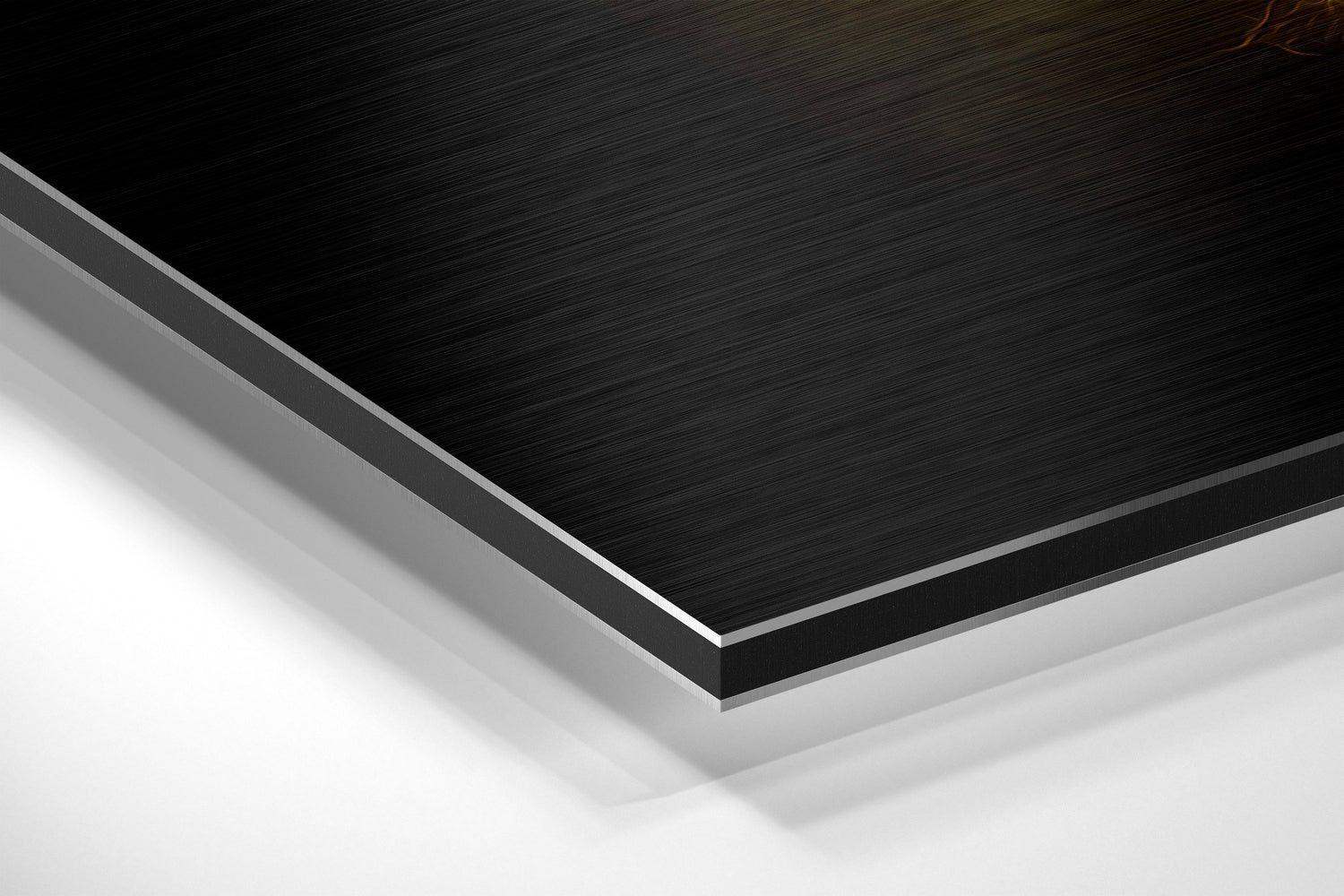 Close-up angled view of layered Dibond panel showing black brushed aluminum top surface with gray and white layers visible along beveled edge.