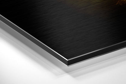 Close-up angled view of layered Dibond panel showing black brushed aluminum top surface with gray and white layers visible along beveled edge.