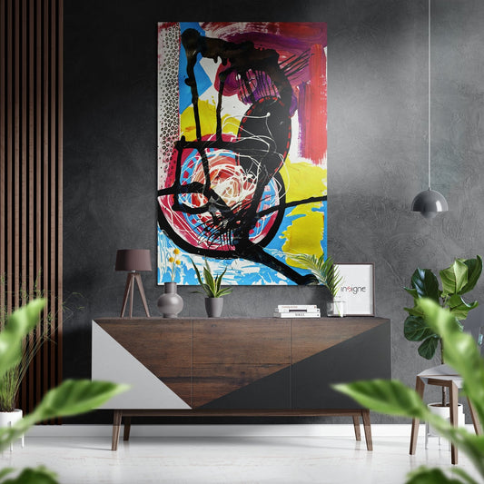 Vibrant abstract artwork with black drip lines and primary colors displayed above a wooden dresser in a modern interior setting.