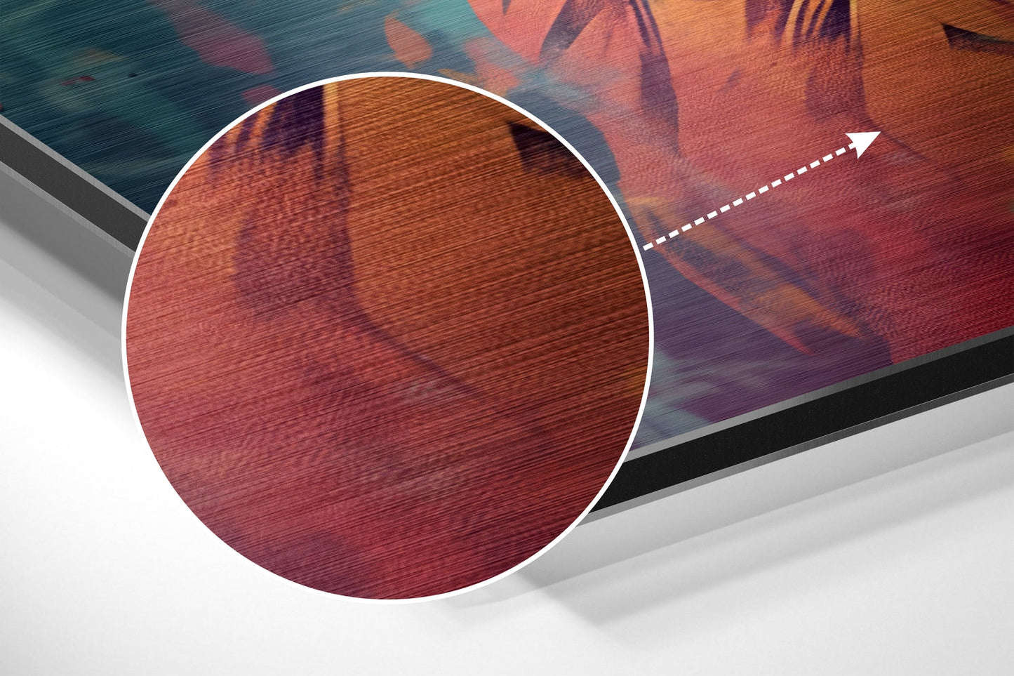 Close-up detail showing brushed aluminum texture of red and orange tones with circular magnification highlight and directional arrow.