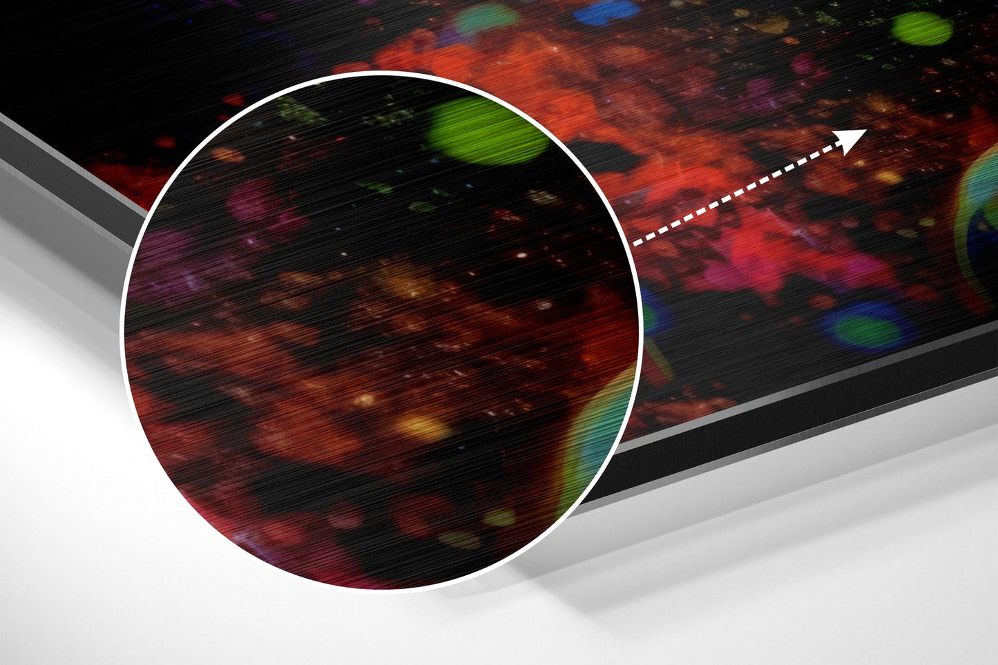 Close-up angled view of brushed aluminum wall art with colorful abstract red, orange, and green bokeh patterns and white circular border detail.