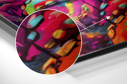 Angled close-up detail of colorful DJ Octopus brushed aluminum wall art showing vibrant magenta, red, orange, yellow, and cyan abstract design with motion blur effect.
