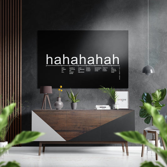 Modern living room with black laughter scale typography art mounted above wooden console table with plants and decor.