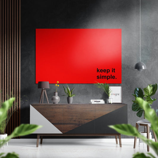 Modern living room interior with red aluminum wall panel displaying "keep it simple" text above wooden credenza with potted plants and pendant lamp.