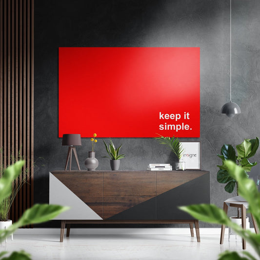 Modern living room with red panel displaying "keep it simple" text mounted above wooden credenza with potted plants and pendant light.