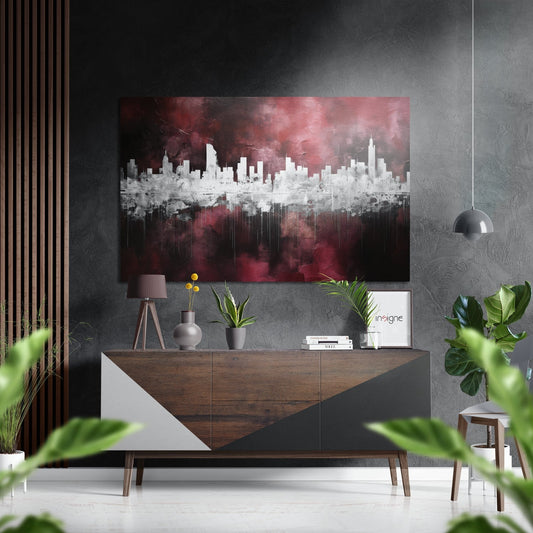 Modern living room interior featuring burgundy and white cityscape wall art above a wood and white sideboard with plants and decor.